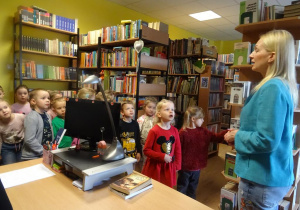 Dzieci słuchają z uwagą pani Małgorzaty Hofmann, która opowiada o swojej pracy.